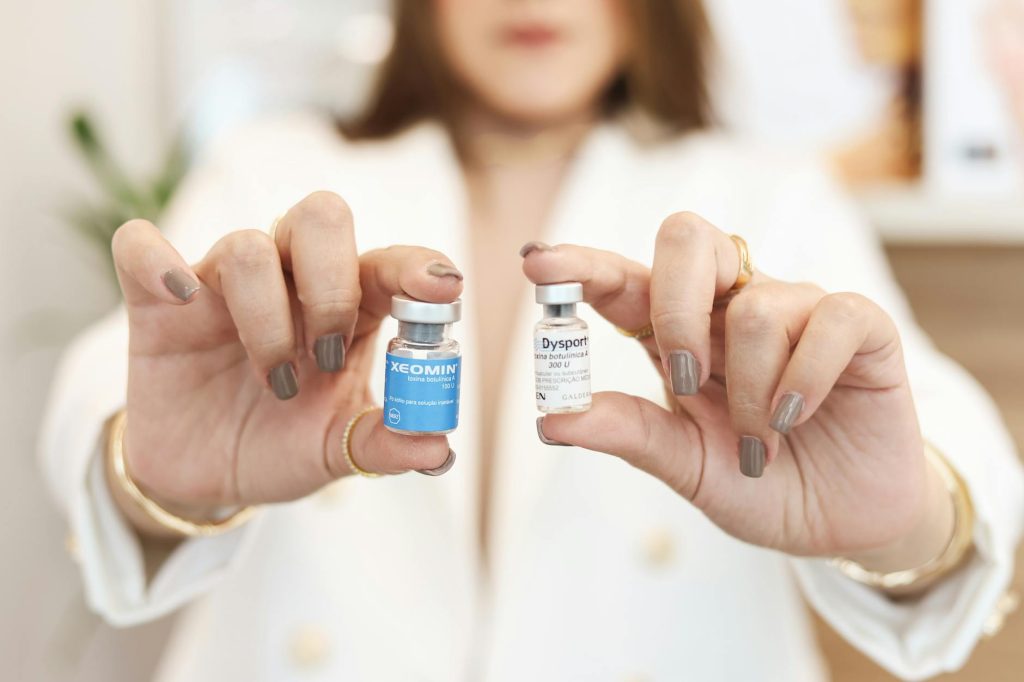 a woman holding two bottles of skin care products